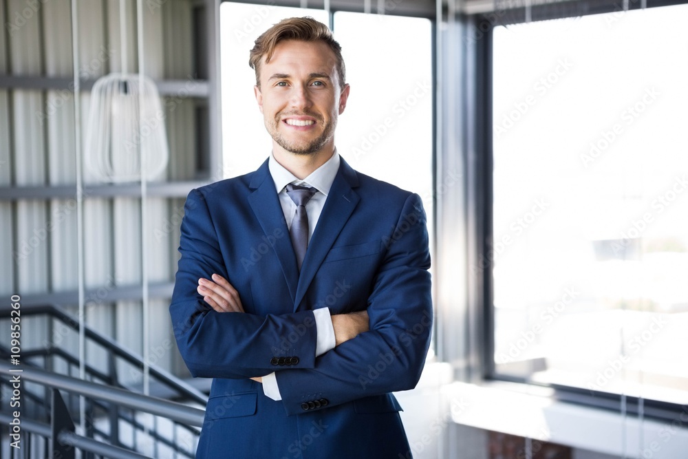 Fototapeta premium Businessman standing with arms crossed
