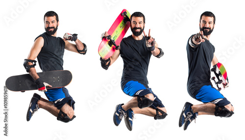Skater jumping doing victory gesture