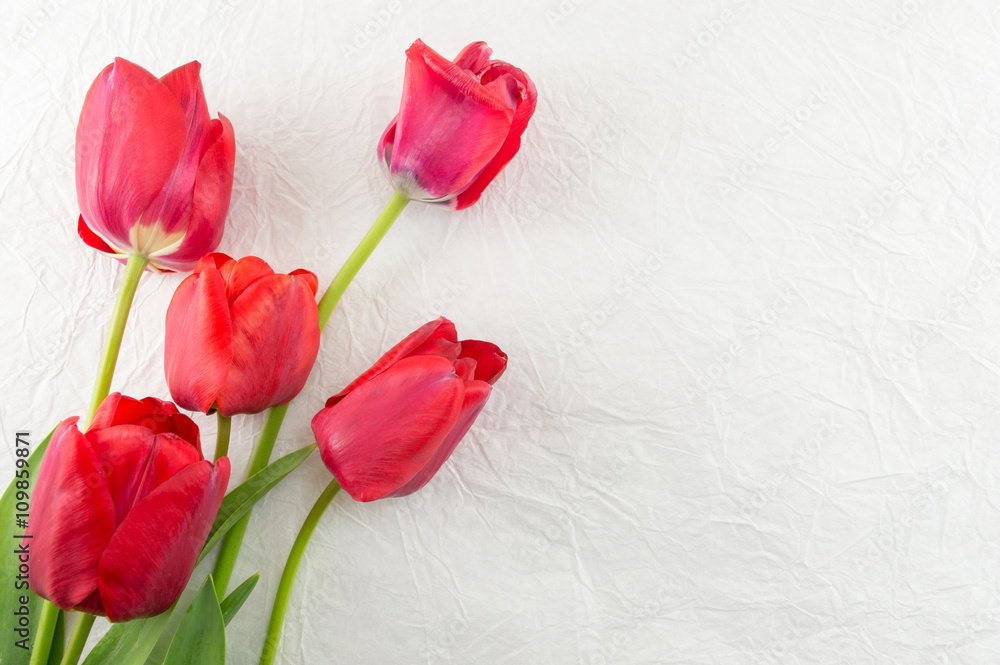 Red tulips on a wooden table