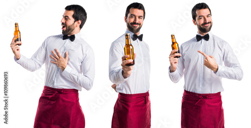 Waiter holding a beer