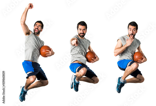 Man playing basketball and pointing to the front