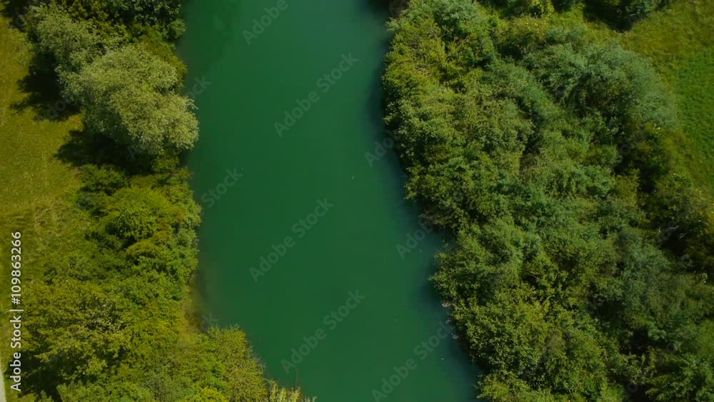 Aerial camera face 90 degree down and slowly pan over the green river in nature.
Aerial camera face 90 degree down and slowly pan over the green river in nature.