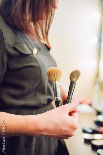 Makeup artist ready to work on a client. Closeup brush in hand