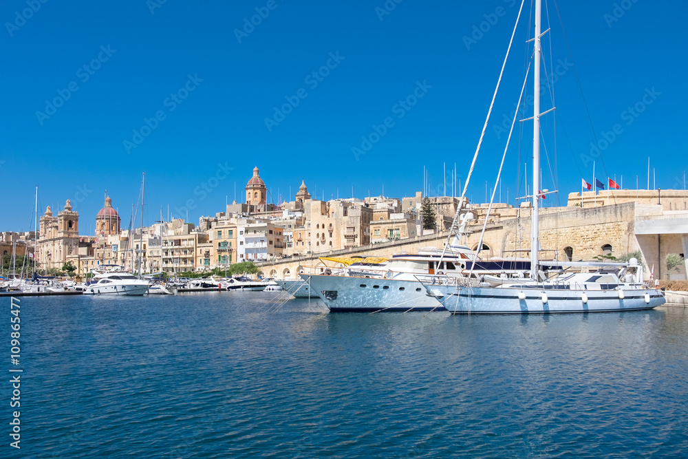 Sailing boats on Senglea marina in Grand Bay, Valetta, Malta, on a bright sunny morning