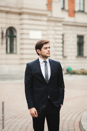 Handsome stylish young businessman posing portrait outdoor