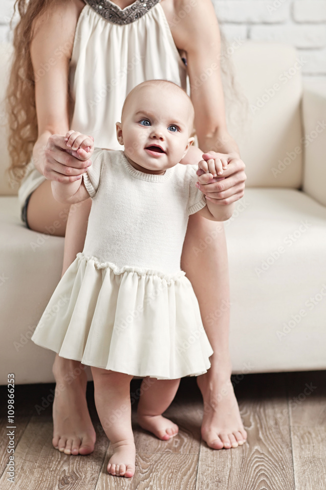 Happy family. Mother and baby daughter plays, hugging, kissing a Happy family. Mother and baby daughter plays, hugging, kissing a