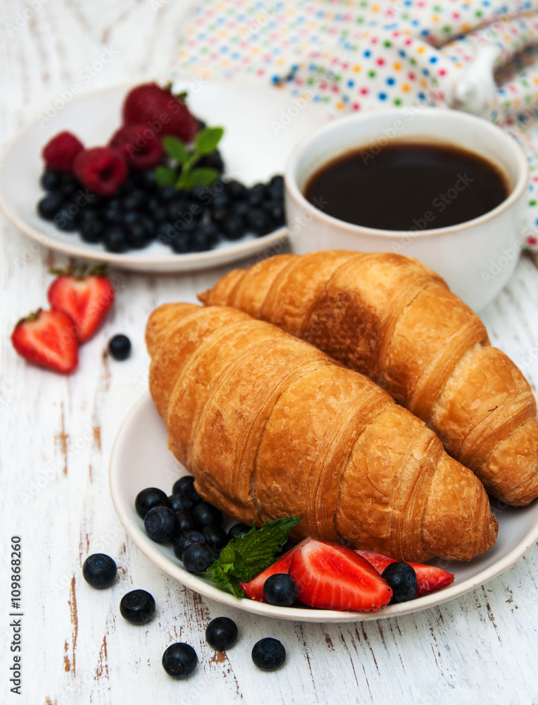Fresh berries, coffee and croissant Fresh berries, coffee and croissant