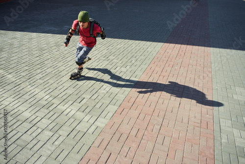 Guy rides on roller skates on the pavement
