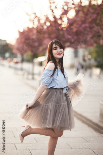 Young Asians girl with modern dress posing in an old Krakow