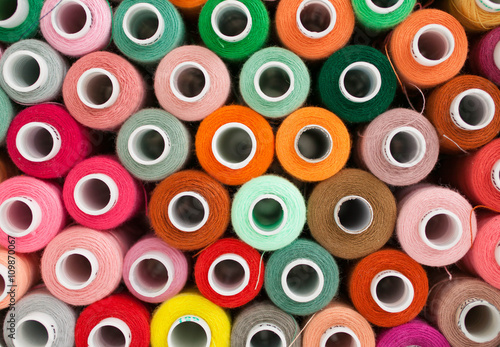 Thread for sewing. Many colorful spools of thread for sewing, colorful background