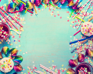 Happy birthday frame. Party tools with cake, drinks and confetti on turquoise shabby chic background, top view, place for text. Happy birthday greeting card