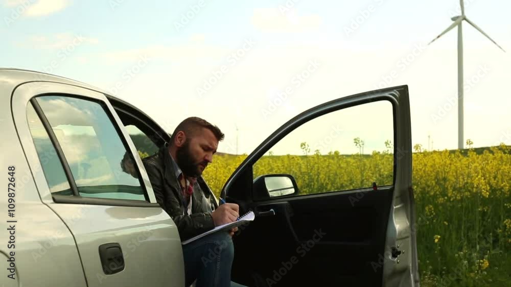 Pensive man note, sitting in car
Pensive man note, sitting in car