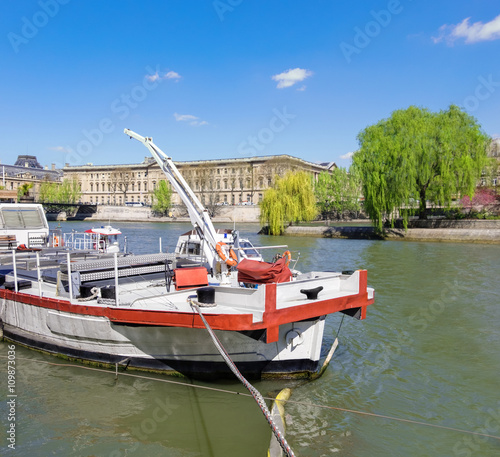 White-red boat on the river in central Paris