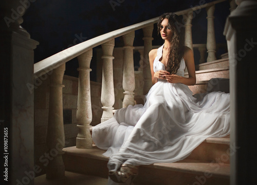 Beautiful, emotional, sexy lady, woman sitting on stairs in dark