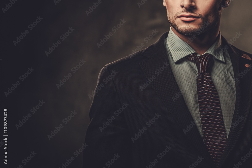Serious well-dressed hispanic man posing on dark background. - obrazy, fototapety, plakaty 