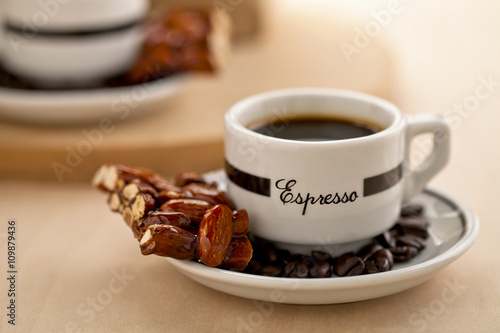 black coffee with coffee beans and almond bar