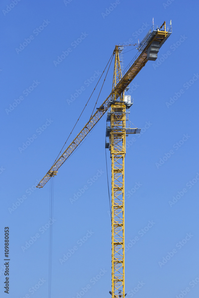 Construction site with cranes against blue sky Construction site with cranes against blue sky
