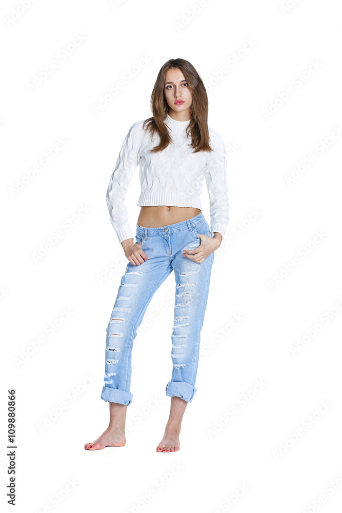 Portrait of a beautiful woman in blue jeans and white sweater Portrait of a beautiful woman in blue jeans and white sweater