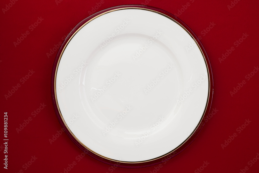 white plate on a red background white plate on a red background