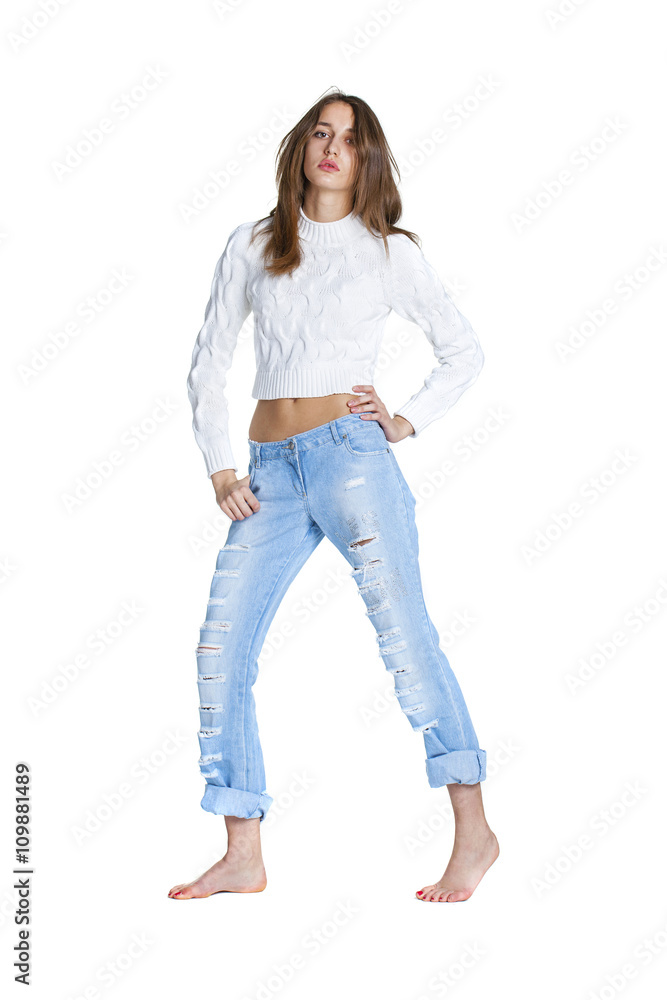 Portrait of a beautiful woman in blue jeans and white sweater Portrait of a beautiful woman in blue jeans and white sweater