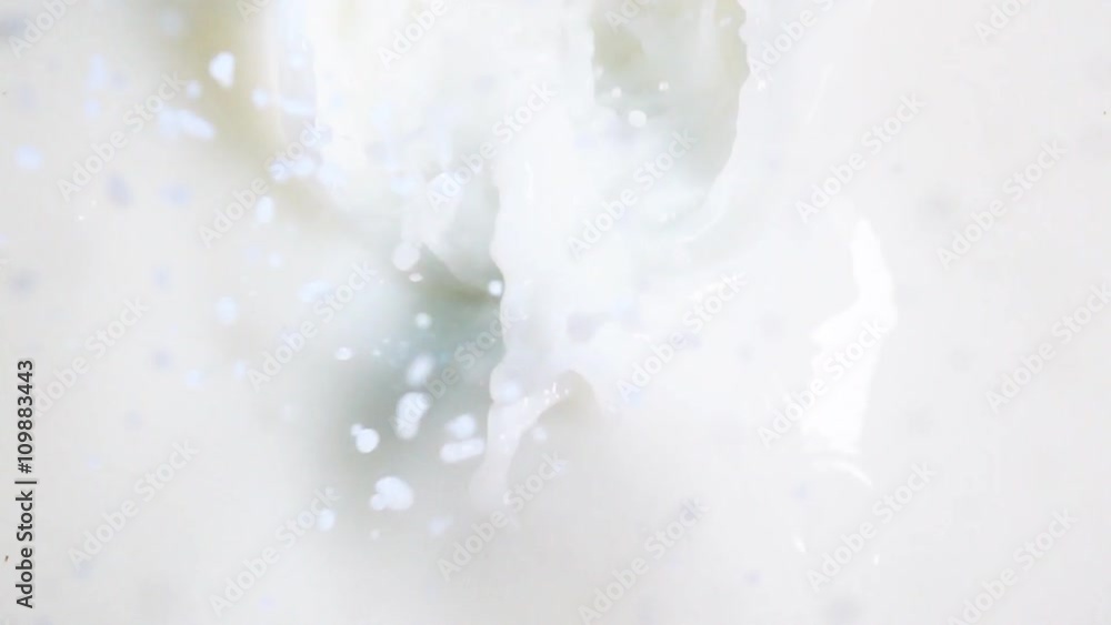 Tasty healthy green apple falling into the milk with stunning splash. Shot made with high speed camera in slow motion mode. Vertical camira static shooting. Tasty healthy green apple falling into the milk with stunning splash. Shot made with high speed camera in slow motion mode. Vertical camira static shooting.