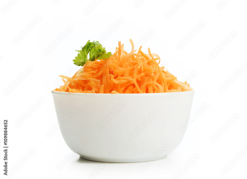 Grated carrots in a white cup on a white background Grated carrots in a white cup on a white background