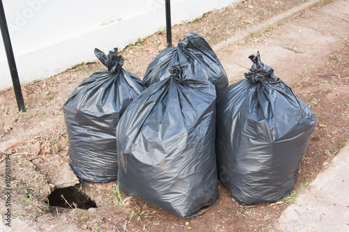 Plastic trash bags on outside street office © Achira22