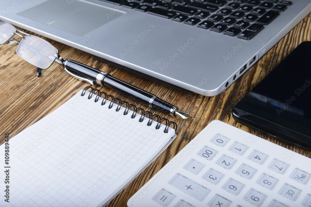 business concept of laptop, smart phone, notebook, pen on a wood business concept of laptop, smart phone, notebook, pen on a wood