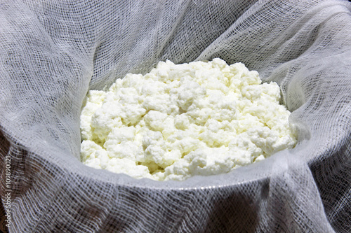 Home made Cottage cheese or Indian Paneer cheese in a cheese cloth.
