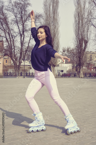 Girl rides on roller skates. © alexshalamov