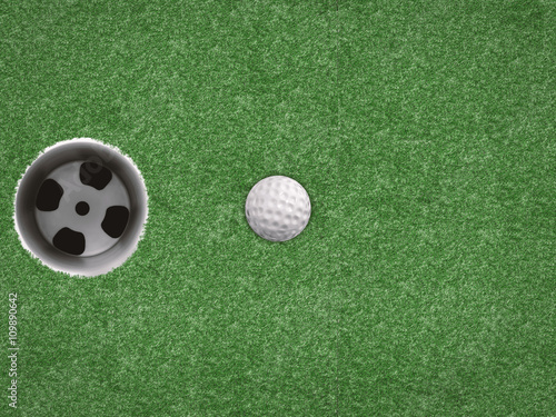 top view golf ball with golf cup on green background