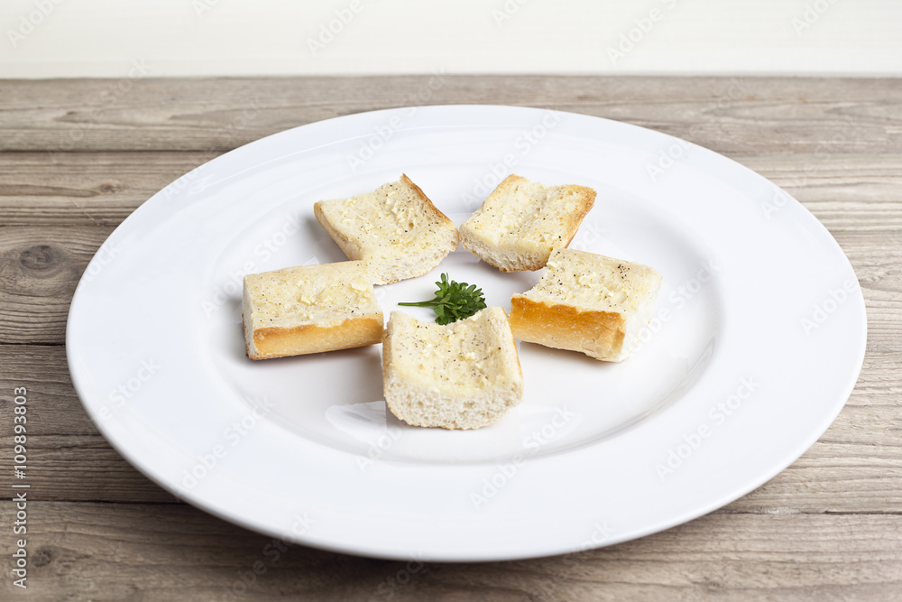 buttered toasted bread in white plate