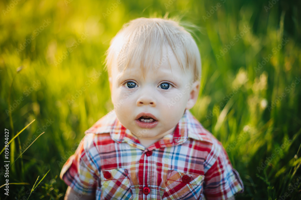 Frustrated child on a background of grass Frustrated child on a background of grass