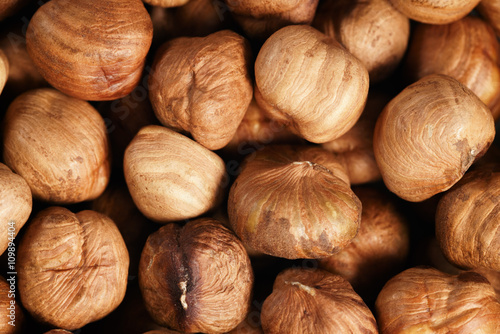 peeled hazelnuts directly from above, food background