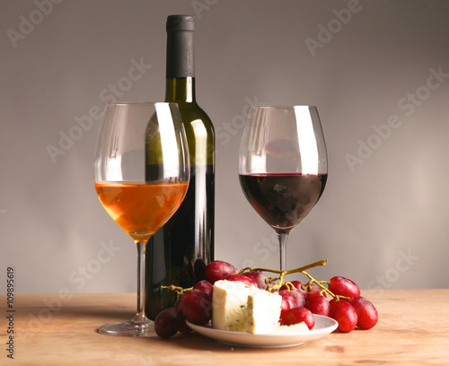 wine bottle and wine glass on a glass table