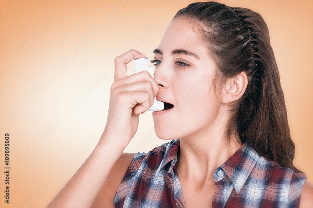 Composite image of woman having asthma using the asthma inhaler Composite image of woman having asthma using the asthma inhaler
