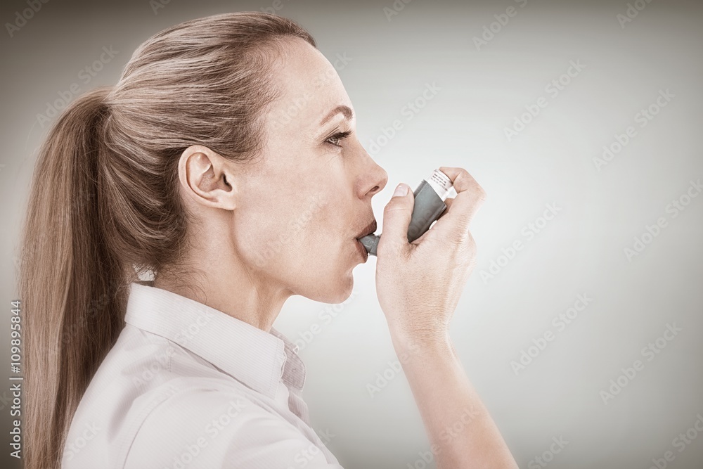 Composite image of pretty blonde using an asthma inhaler - obrazy, fototapety, plakaty 