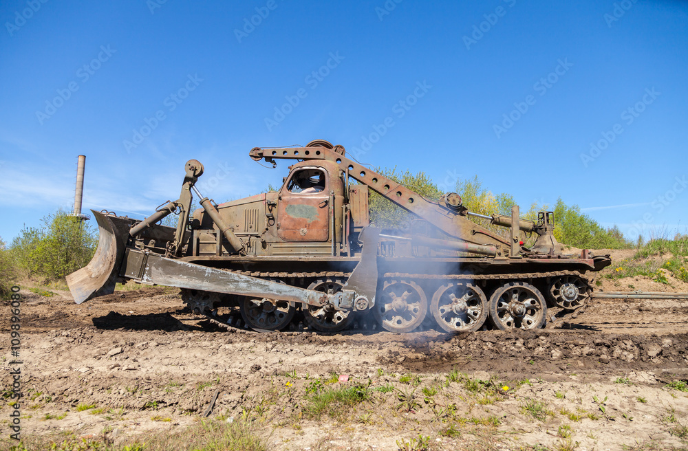 Fototapeta premium soviet military bulldozer drives on track 