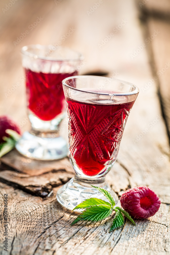 Homemade liqueur made of alcohol and raspberries Homemade liqueur made of alcohol and raspberries