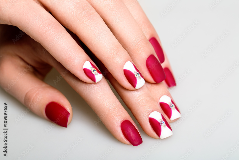 Beautiful woman's nails with interesting red manicure Beautiful woman's nails with interesting red manicure