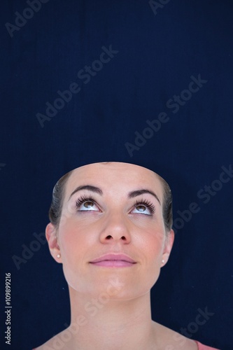 Composite image of close-up of beautiful woman looking up