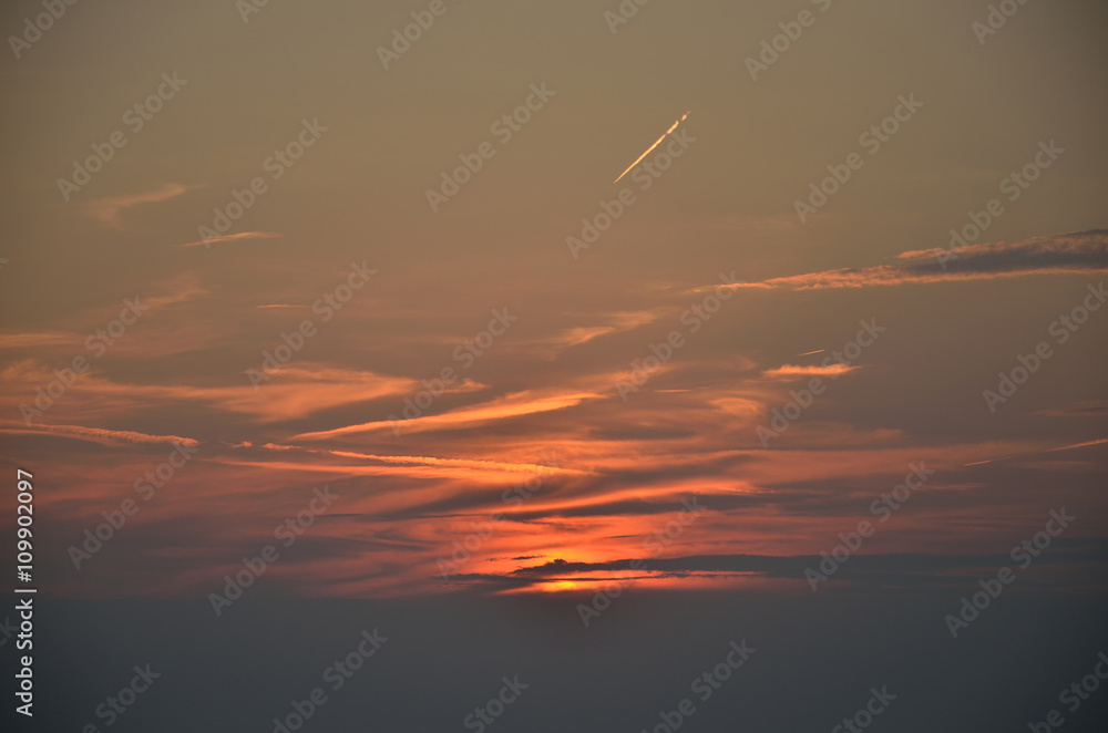 Sunset sky with plane trace