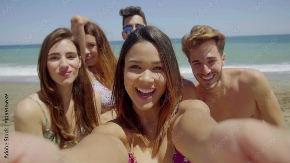 Head and Shoulders Group Portrait of Young Adult Friends Wearing Swim Suits and Having Fun on Sunny Beach with View of Ocean in Background Head and Shoulders Group Portrait of Young Adult Friends Wearing Swim Suits and Having Fun on Sunny Beach with View of Ocean in Background