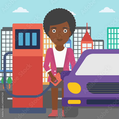 Woman filling up fuel into car.