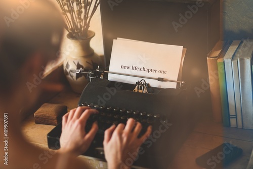 New life chapter one against young woman using typewriter