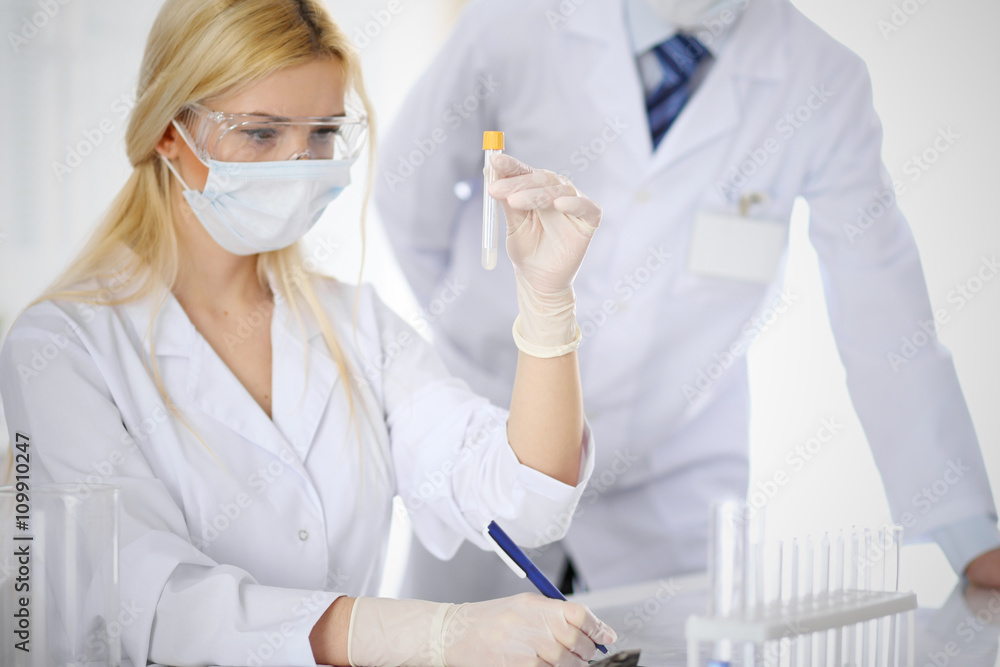 Scientific research team with clear solution in laboratory Scientific research team with clear solution in laboratory