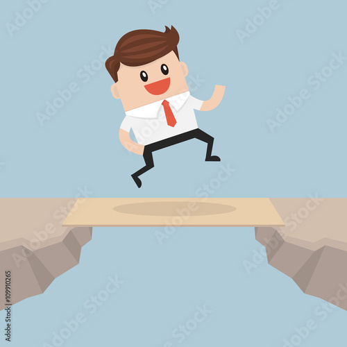 Businessman cross the cliff gap by wooden board as a bridge