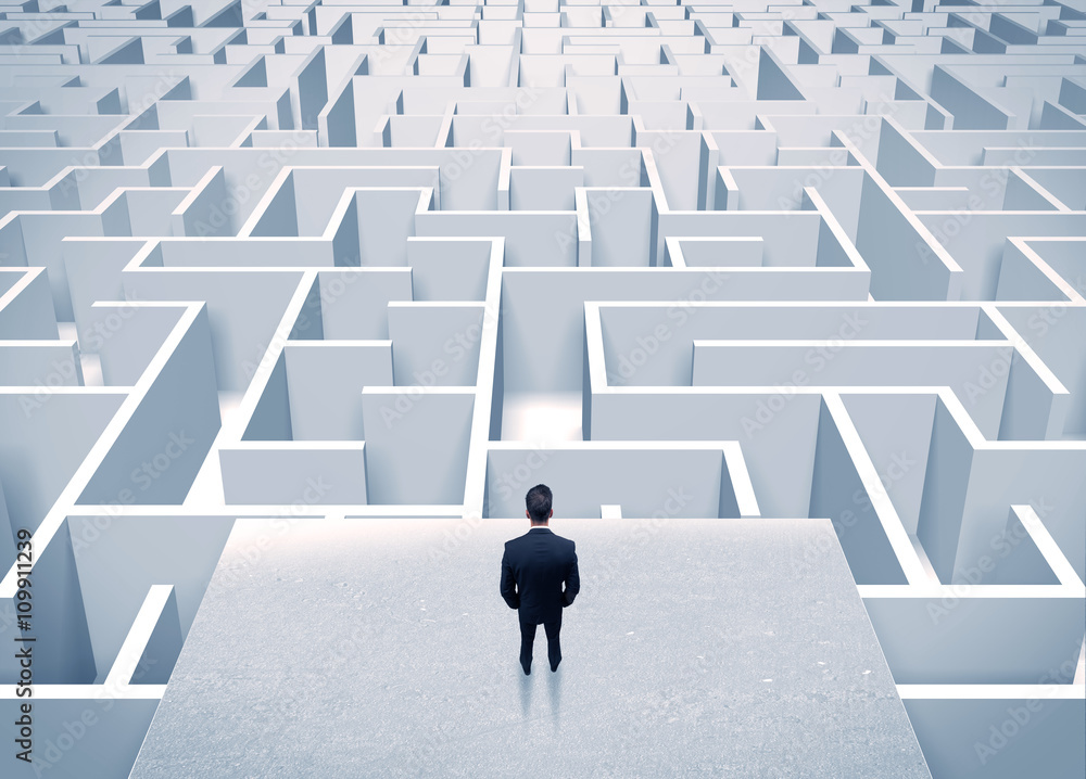 Businessman staring at infinite maze Businessman staring at infinite maze