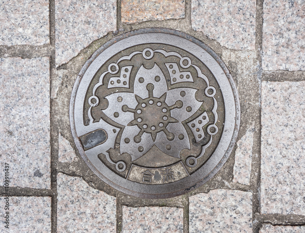 Circle steel manhole cover on polished stone