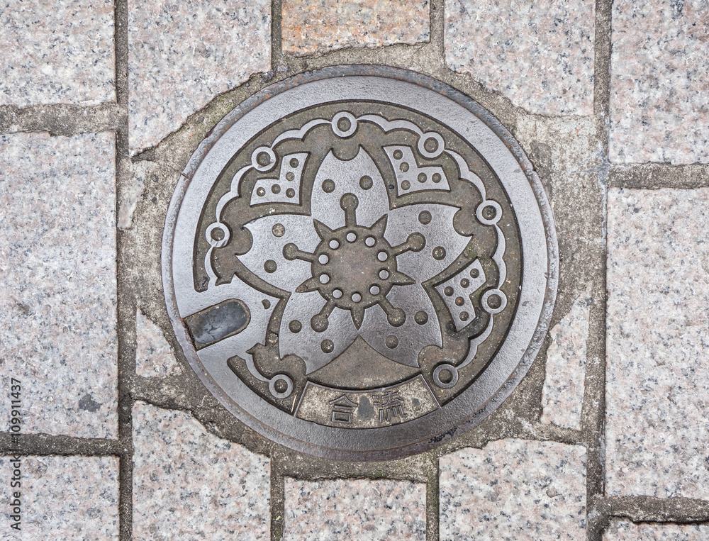 Circle steel manhole cover on polished stone Circle steel manhole cover on polished stone